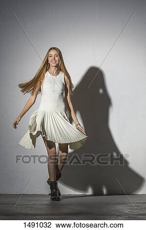 Portrait of woman spinning against white background View Large Photo Image Stock Image - Portrait of woman spinning against white background. Fotosearch