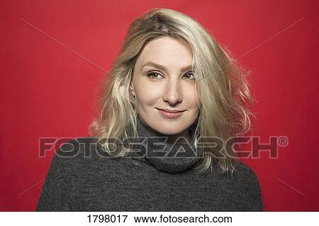 Portrait of woman with blond hair smiling and wearing gray turtleneck sweater View Large Photo Image Stock Photo - Portrait of woman with blond hair smiling and wearing gray turtleneck sweater. Fotosearch