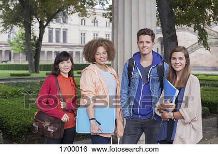 Portrait of young friends standing against column, Berlin, Germany View Large Photo Image Stock Photograph - Portrait of young friends standing against column, Berlin, Germany. Fotosearch