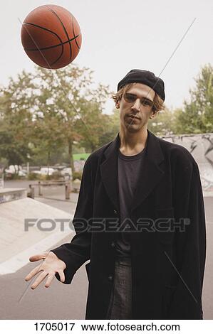 Portrait of young man playing basketball at park View Large Photo Image Stock Photo - Portrait of young man playing basketball at park. Fotosearch