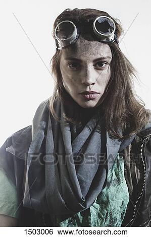 Portrait of young woman wearing goggles and jacket against white background View Large Photo Image Stock Photograph - Portrait of young woman wearing goggles and jacket against white background. Fotosearch