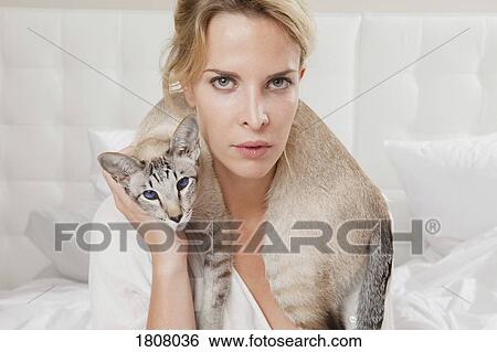 Portrait sensual woman with cat wrapped around neck View Large Photo Image Stock Photograph - Portrait sensual woman with cat wrapped around neck. Fotosearch
