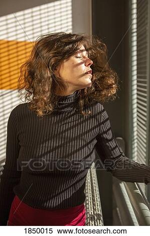 Portrait sensual young woman at sunny window View Large Photo Image Stock Photography - Portrait sensual young woman at sunny window. Fotosearch
