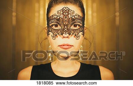 Stock Photography - Portrait serious, beautiful woman in masquerade mask. Fotosearch