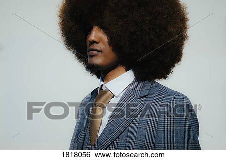 Stock Photograph - Portrait serious well-dressed young man with afro. Fotosearch