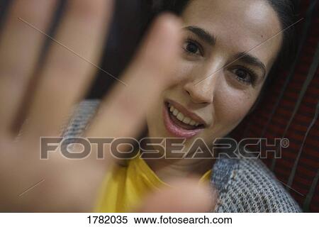 Stock Photography - Portrait shy woman blocking camera. Fotosearch