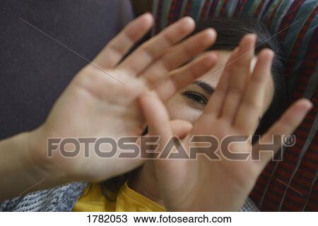Portrait shy woman with hands in front of face View Large Photo Image Stock Image - Portrait shy woman with hands in front of face. Fotosearch