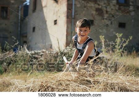 Portrait smiling boy working on sunny farm View Large Photo Image Stock Photo - Portrait smiling boy working on sunny farm. Fotosearch