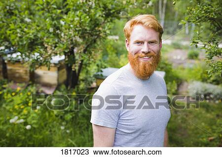 Portrait smiling, confident man with red hair in garden View Large Photo Image Stock Image - Portrait smiling, confident man with red hair in garden. Fotosearch