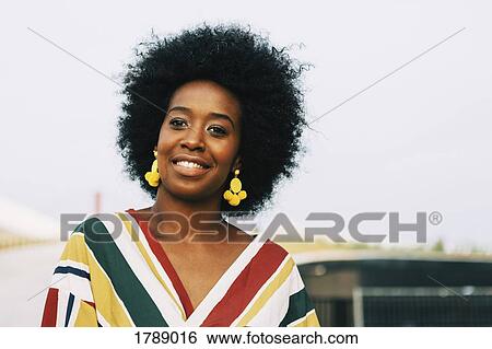 Stock Photograph - Portrait smiling, confident young woman. Fotosearch