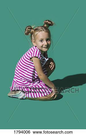 Stock Photograph - Portrait smiling girl against green background. Fotosearch