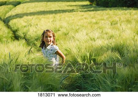 Portrait smiling girl in rural, green wheat field View Large Photo Image Stock Image - Portrait smiling girl in rural, green wheat field. Fotosearch