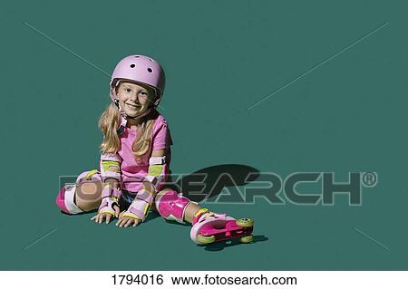 Portrait smiling girl roller skating on green background View Large Photo Image Stock Photograph - Portrait smiling girl roller skating on green background. Fotosearch