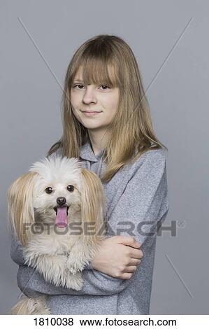 Portrait smiling tween girl holding dog View Large Photo Image Stock Photo - Portrait smiling tween girl holding dog. Fotosearch