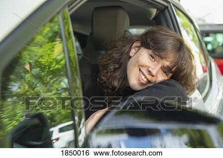 Portrait smiling woman driving car View Large Photo Image Stock Photograph - Portrait smiling woman driving car. Fotosearch