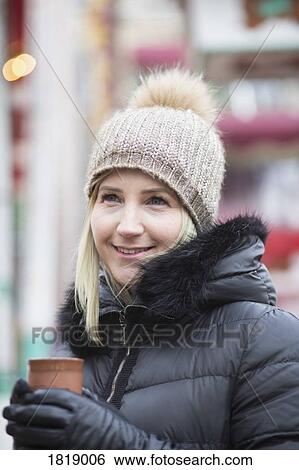 Portrait smiling woman in warm clothing drinking tea View Large Photo Image Stock Photograph - Portrait smiling woman in warm clothing drinking tea. Fotosearch