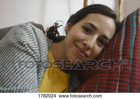 Portrait smiling woman relaxing, laying on pillow View Large Photo Image Picture - Portrait smiling woman relaxing, laying on pillow. Fotosearch