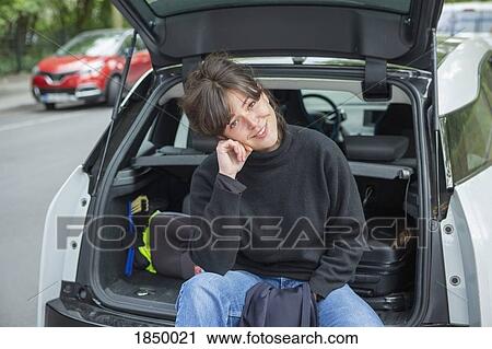 Portrait smiling young woman sitting at back of car View Large Photo Image Stock Image - Portrait smiling young woman sitting at back of car. Fotosearch