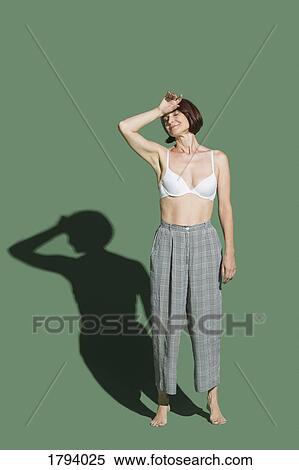 Portrait tired woman in bra against green background View Large Photo Image Stock Photography - Portrait tired woman in bra against green background. Fotosearch