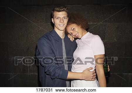 Stock Image - Portrait young couple hugging. Fotosearch