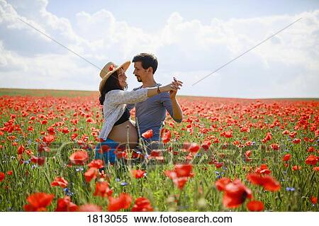 Pregnant couple dancing in sunny, idyllic rural red poppy field View Large Photo Image Stock Photography - Pregnant couple dancing in sunny, idyllic rural red poppy field. Fotosearch