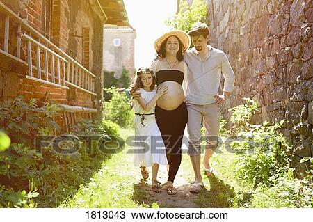 Pregnant family walking along sunny farmhouse View Large Photo Image Stock Image - Pregnant family walking along sunny farmhouse. Fotosearch