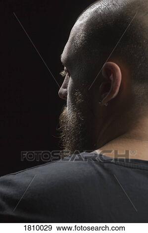 Stock Photo - Profile serious man with beard and earring. Fotosearch