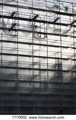 Protective sheeting over highrise building under construction View Large Photo Image Stock Image - Protective sheeting over highrise building under construction. Fotosearch