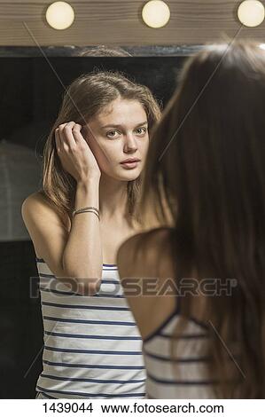 Rear view of beautiful woman looking in mirror View Large Photo Image Picture - Rear view of beautiful woman looking in mirror. Fotosearch