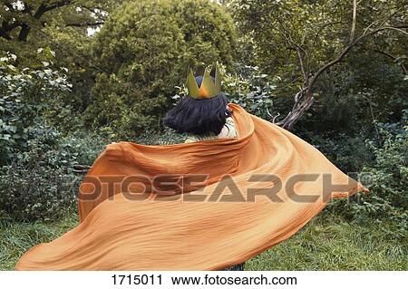 Rear view of woman wearing crown waving scarf against trees at park View Large Photo Image Stock Image - Rear view of woman wearing crown waving scarf against trees at park. Fotosearch