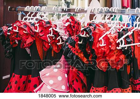 Red and black polka-dot costume dresses hanging on clothes rack in shop View Large Photo Image Stock Photography - Red and black polka-dot costume dresses hanging on clothes rack in shop. Fotosearch