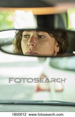 Reflection of woman in rear-view mirror driving car View Large Photo Image Stock Image - Reflection of woman in rear-view mirror driving car. Fotosearch