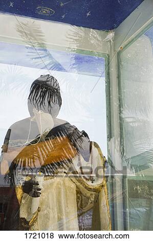 Religious statue seen through glass View Large Photo Image Stock Photo - Religious statue seen through glass. Fotosearch