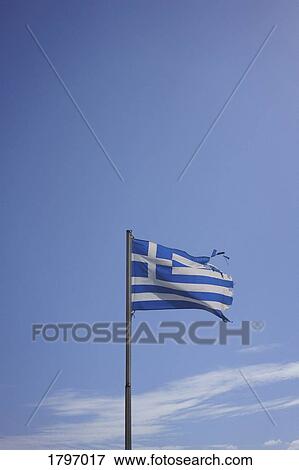 Ripped Greek flag blowing in wind against sunny blue sky View Large Photo Image Stock Photo - Ripped Greek flag blowing in wind against sunny blue sky. Fotosearch