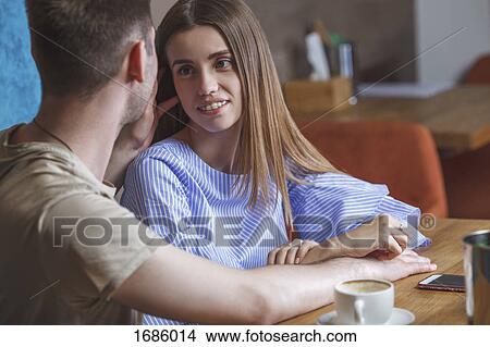Romantic couple sitting face to face at restaurant View Large Photo Image Picture - Romantic couple sitting face to face at restaurant. Fotosearch