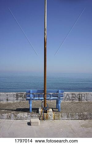 Rusted flagpole and blue bench with scenic ocean view, Kalyves, Crete, Greece View Large Photo Image Picture - Rusted flagpole and blue bench with scenic ocean view, Kalyves, Crete, Greece. Fotosearch