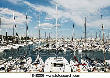 Sailboats moored in sunny Olympic Harbor, Barcelona, Spain View Large Photo Image Stock Photograph - Sailboats moored in sunny Olympic Harbor, Barcelona, Spain. Fotosearch