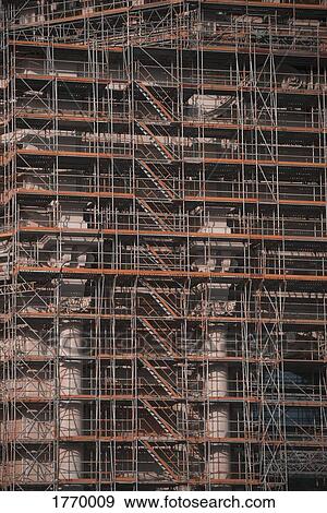 Scaffolding along highrise building under construction View Large Photo Image Stock Photo - Scaffolding along highrise building under construction. Fotosearch