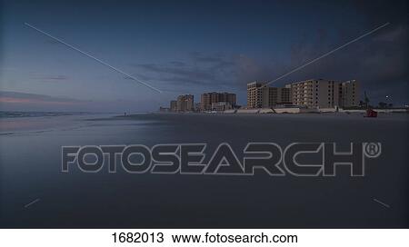 Stock Image - Scenic view of beach against sky during sunset, Daytona, Florida, USA. Fotosearch