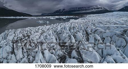 Scenic view of glacier against cloudy sky, Knick Glacier. Palmer, Alaska, USA View Large Photo Image Stock Photo - Scenic view of glacier against cloudy sky, Knick Glacier. Palmer, Alaska, USA. Fotosearch