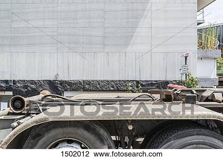 Semi-truck parked on street against building View Large Photo Image Stock Image - Semi-truck parked on street against building. Fotosearch