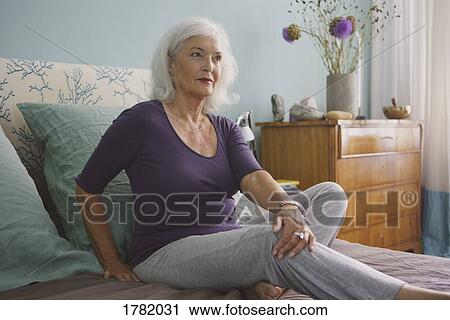 Senior woman relaxing on bed View Large Photo Image Stock Image - Senior woman relaxing on bed. Fotosearch