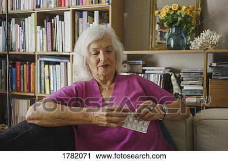 Senior woman taking medication View Large Photo Image Stock Image - Senior woman taking medication. Fotosearch