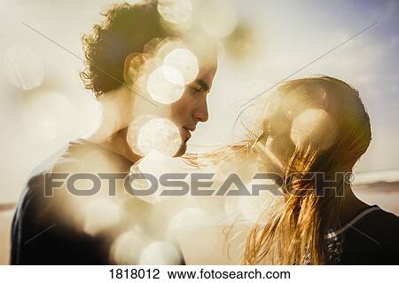 Serene couple on windy, sunny beach View Large Photo Image Stock Image - Serene couple on windy, sunny beach. Fotosearch