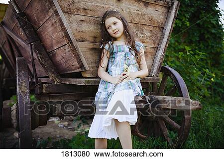 Serene girl in dress with flowers in hair at rural wagon View Large Photo Image Stock Image - Serene girl in dress with flowers in hair at rural wagon. Fotosearch