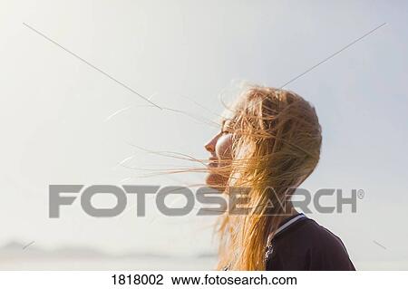 Serene woman basking in sunshine View Large Photo Image Stock Image - Serene woman basking in sunshine. Fotosearch