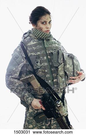 Serious soldier holding rifle and helmet standing against white background View Large Photo Image Stock Image - Serious soldier holding rifle and helmet standing against white background. Fotosearch
