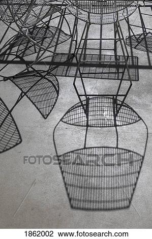 Shadows of iron chairs and table on sunny patio View Large Photo Image Stock Image - Shadows of iron chairs and table on sunny patio. Fotosearch