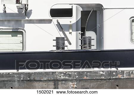Ship moored by retaining wall at harbor View Large Photo Image Stock Image - Ship moored by retaining wall at harbor. Fotosearch