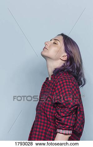 Side portrait of young woman with dyed hair and eyes closed against gray background View Large Photo Image Stock Photo - Side portrait of young woman with dyed hair and eyes closed against gray background. Fotosearch